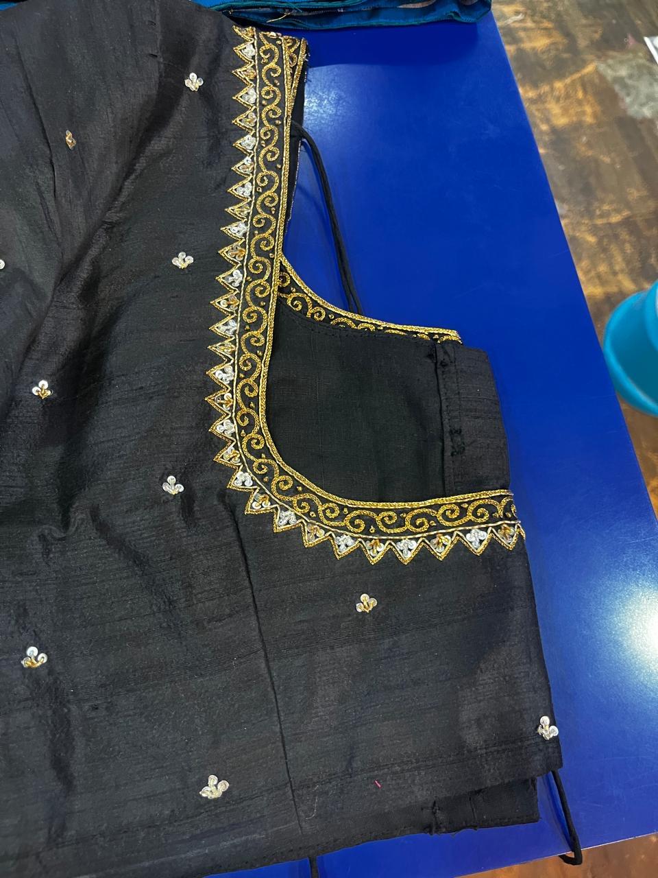 Black designer blouse with gold zari embroidery and floral accents