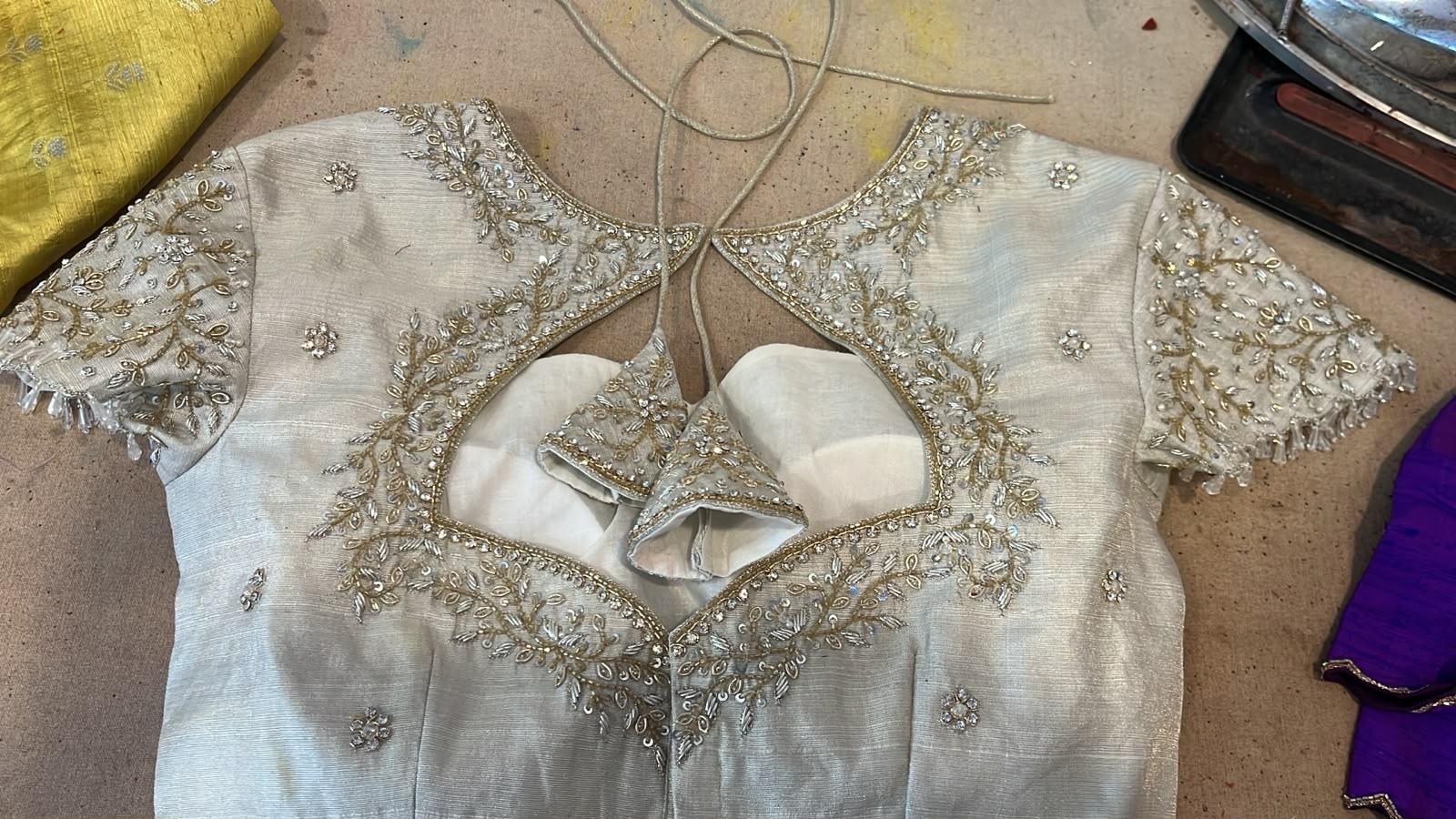 Cream bridal blouse with intricate zari and stone embroidery work