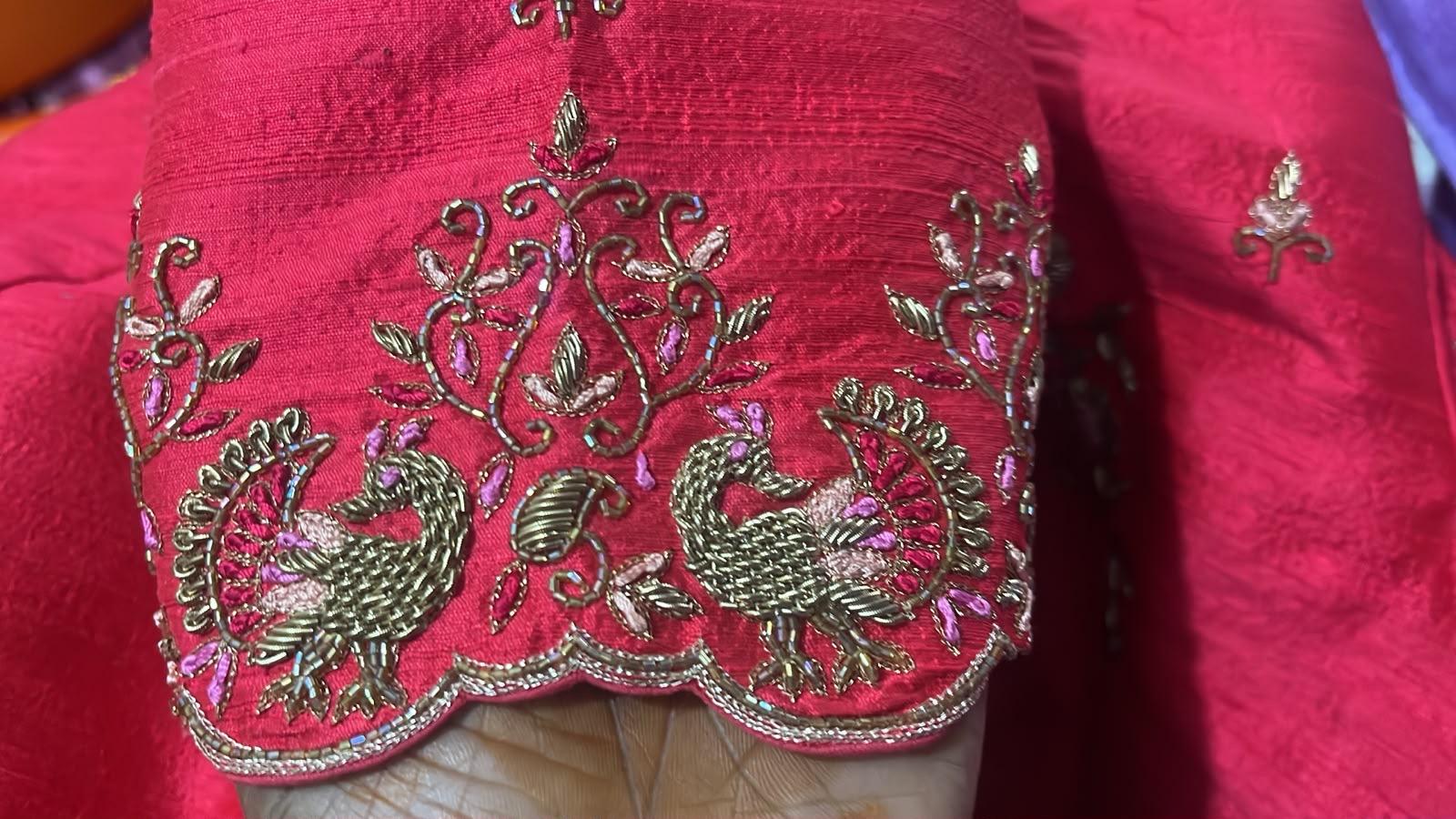 Hot pink bridal blouse with gold zari peacock and floral embroidery