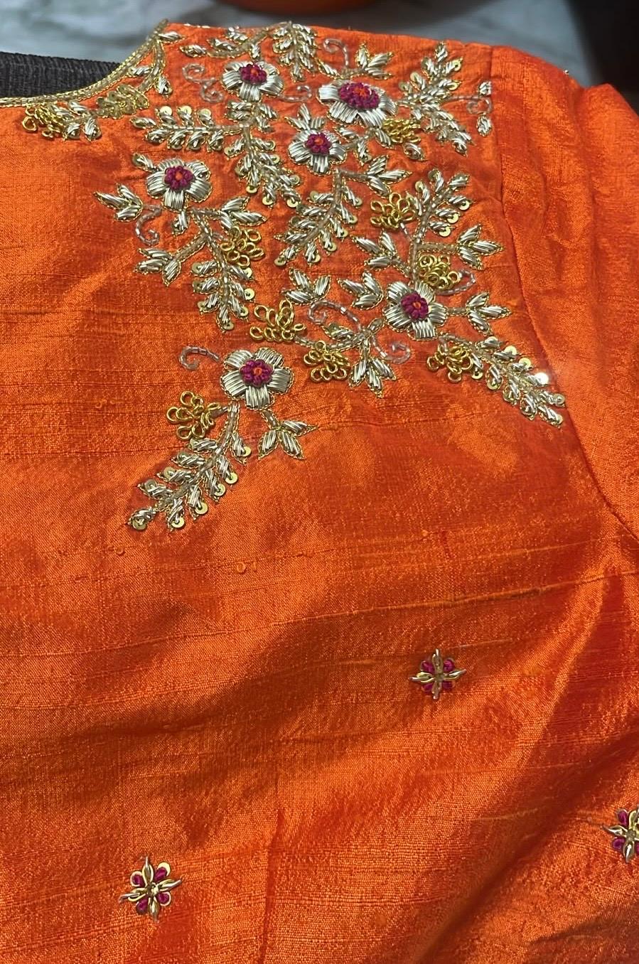 Orange silk blouse with gold zari and maggam floral embroidery