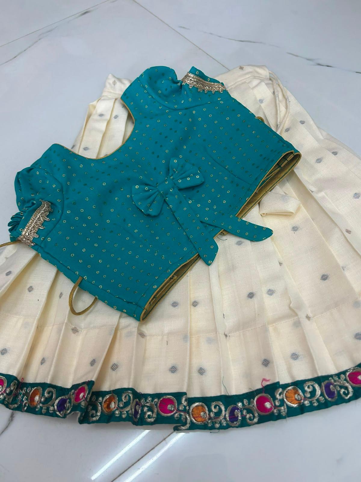 Teal silk blouse with gold sequins and embroidered sleeves, cream skirt