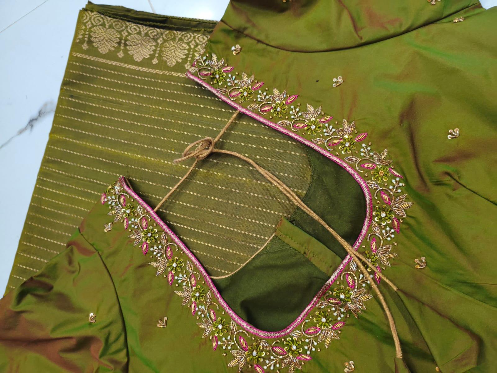 Green silk blouse with pink maggam work embroidery and gold detailing