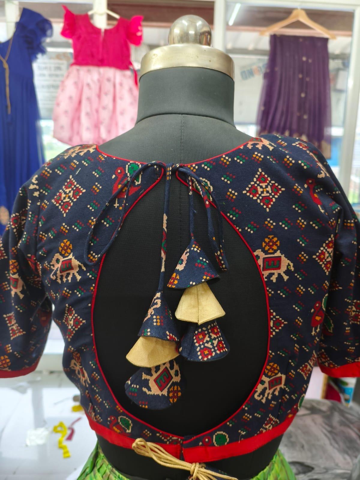Navy blue traditional blouse with colorful geometric and animal motifs embroidery