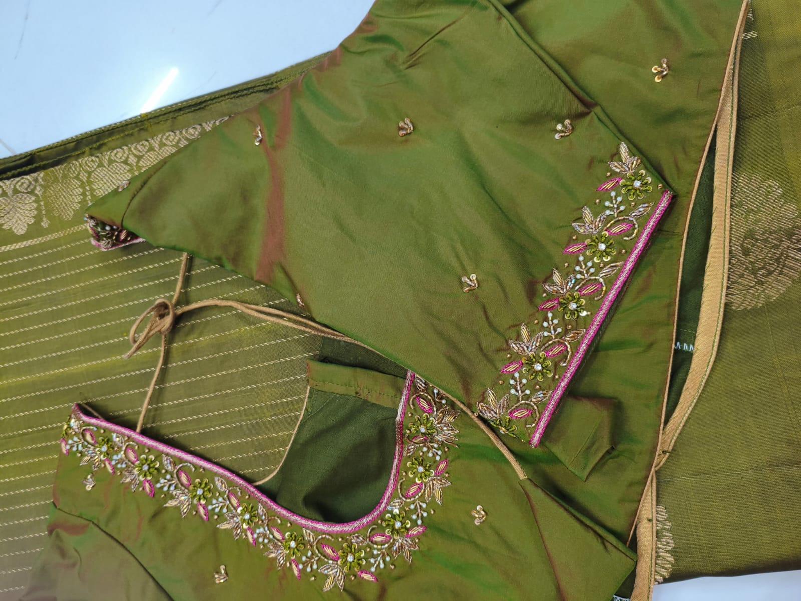 Green saree with magenta embroidered border and scattered buttis
