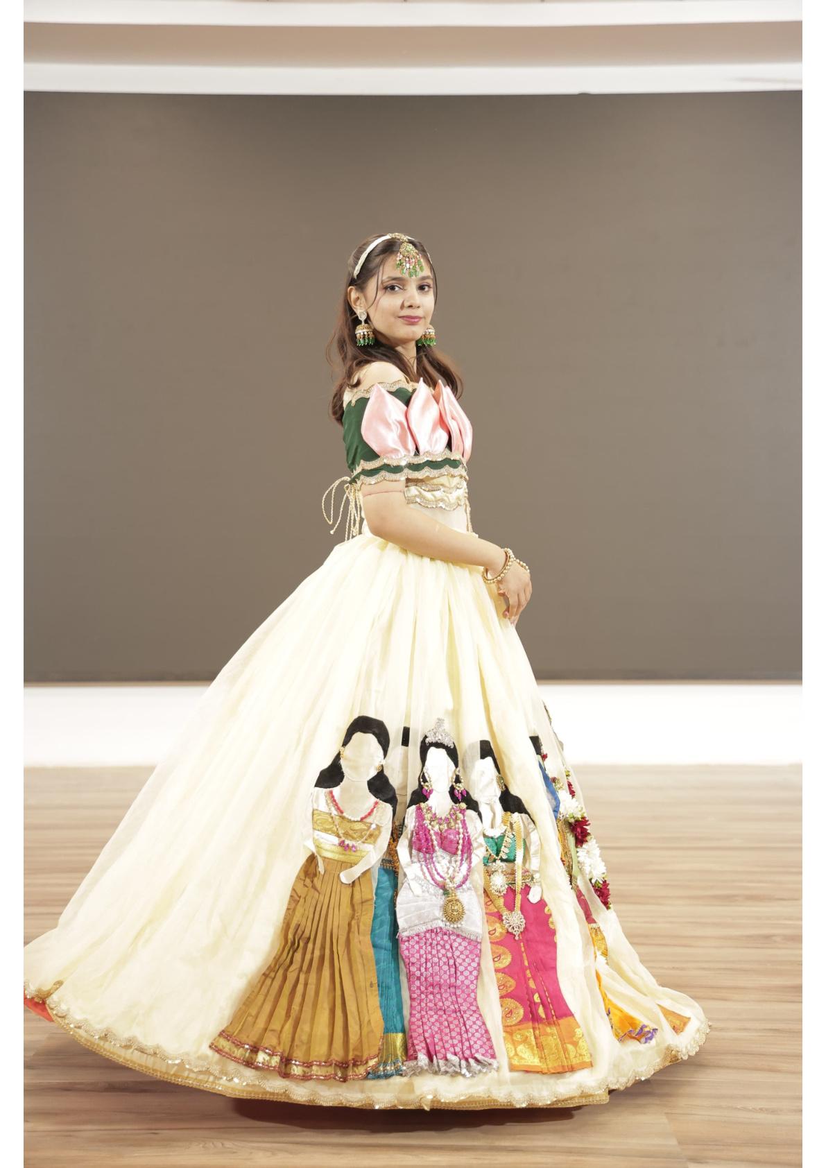 Cream lehenga with illustrated figures, pink blouse, traditional styling