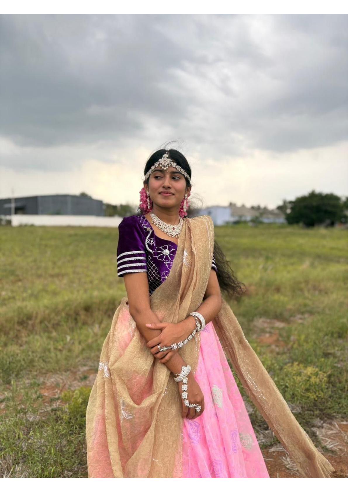 Purple blouse with pink skirt and beige dupatta, embellished with jewelry