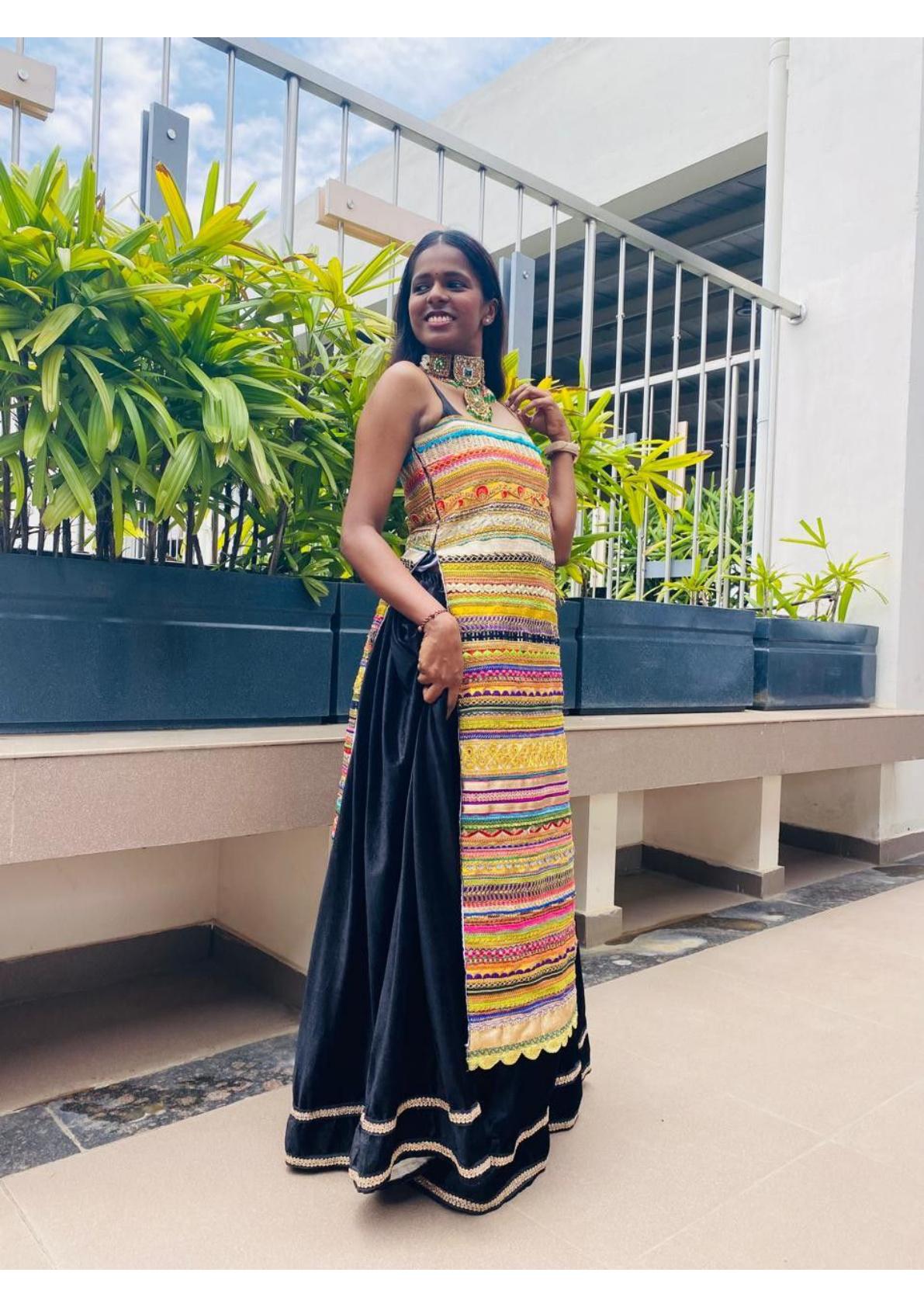 Colorful striped halter blouse with black silk saree and gold trim