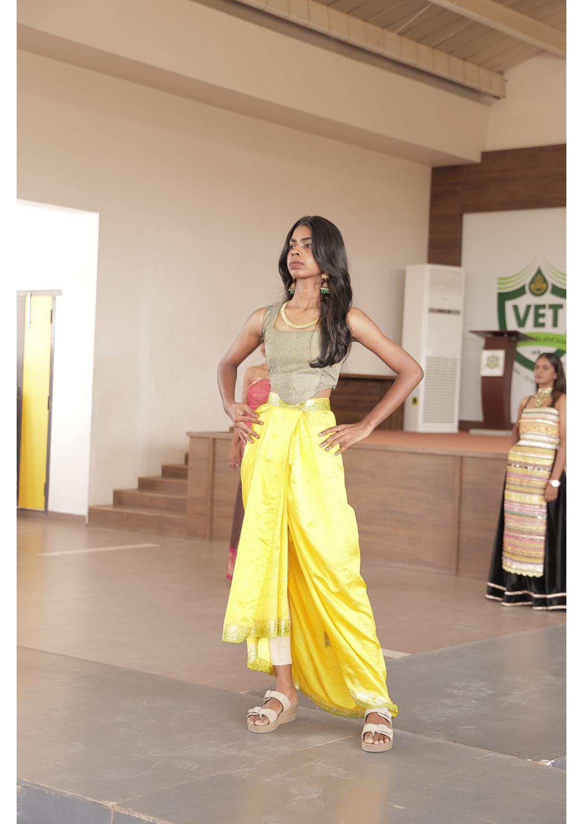 Yellow silk saree with cream blouse and white sandals