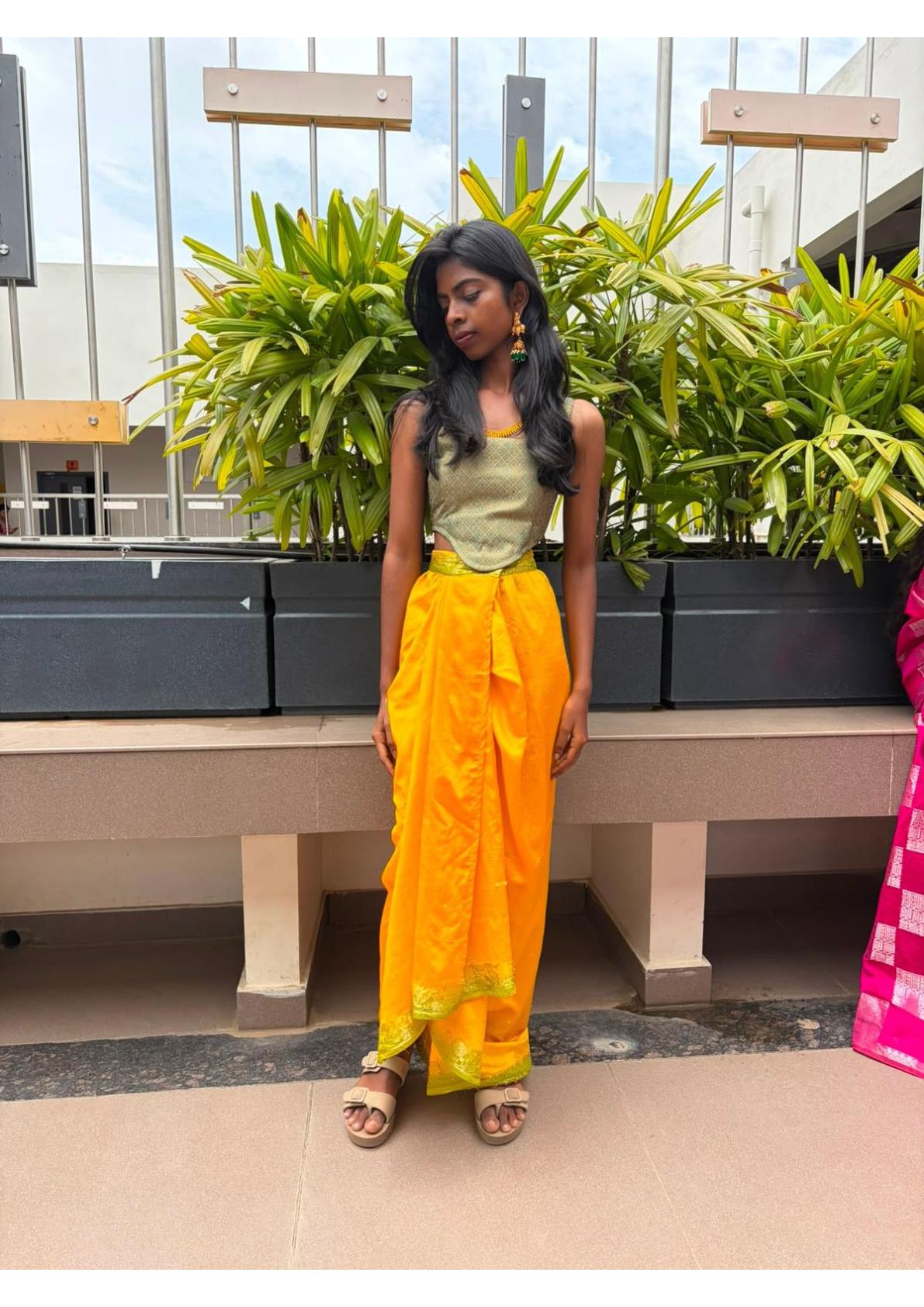 Yellow traditional saree with golden border and green blouse
