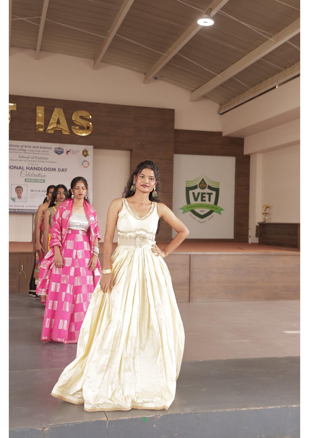 Cream pleated gown with gold border and waist tie detail