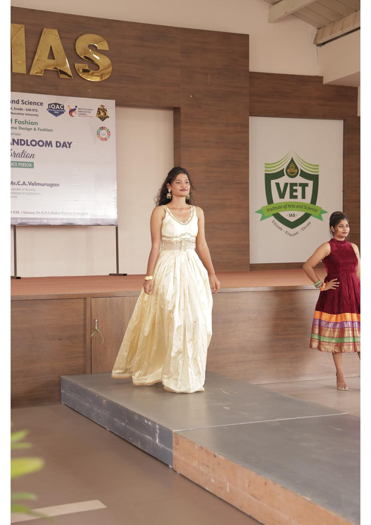 Cream pleated gown with beaded waist belt and sleeveless design