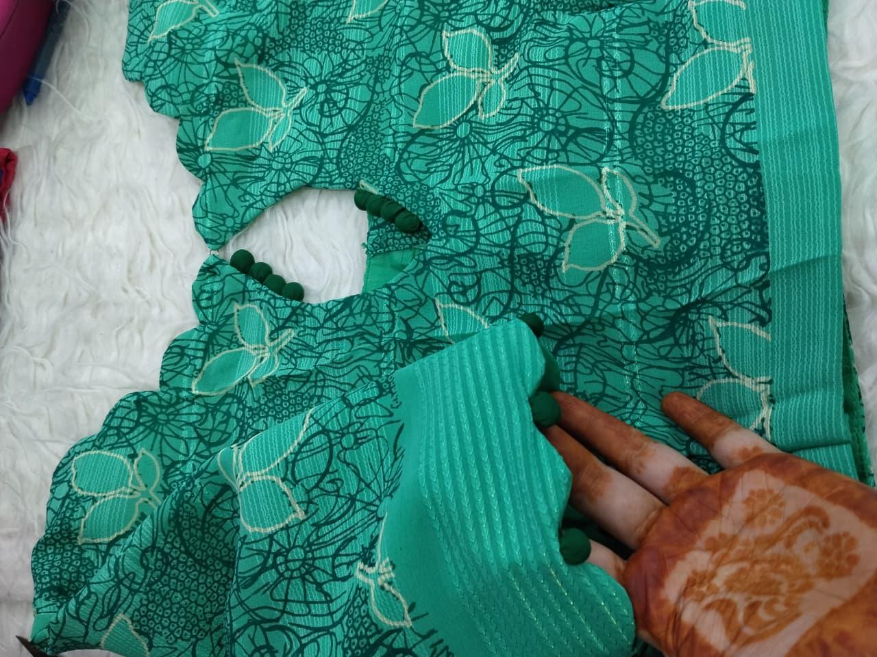 Turquoise saree with intricate floral and geometric lace patterns