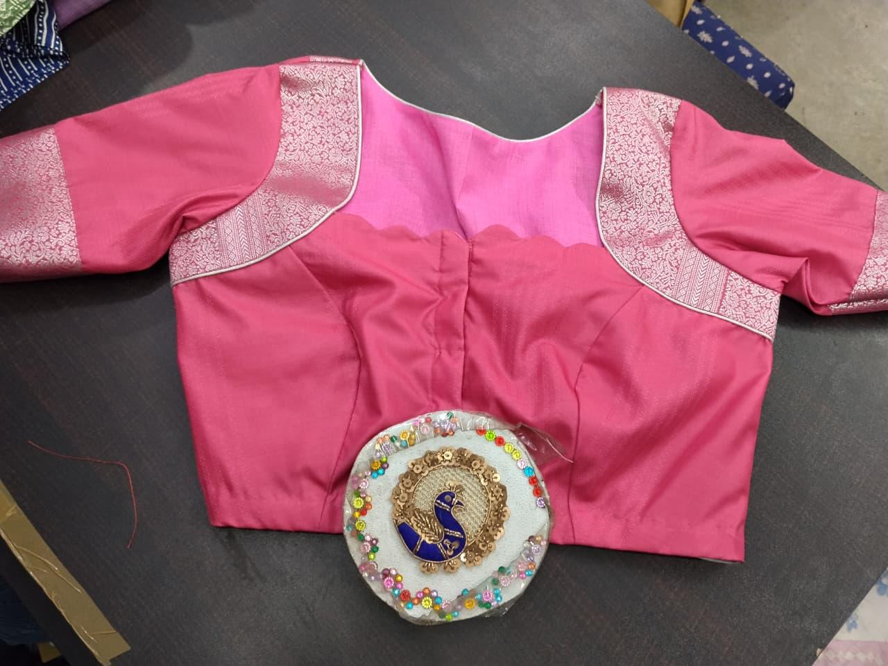 Pink blouse with gold zari embroidery and decorative peacock motif