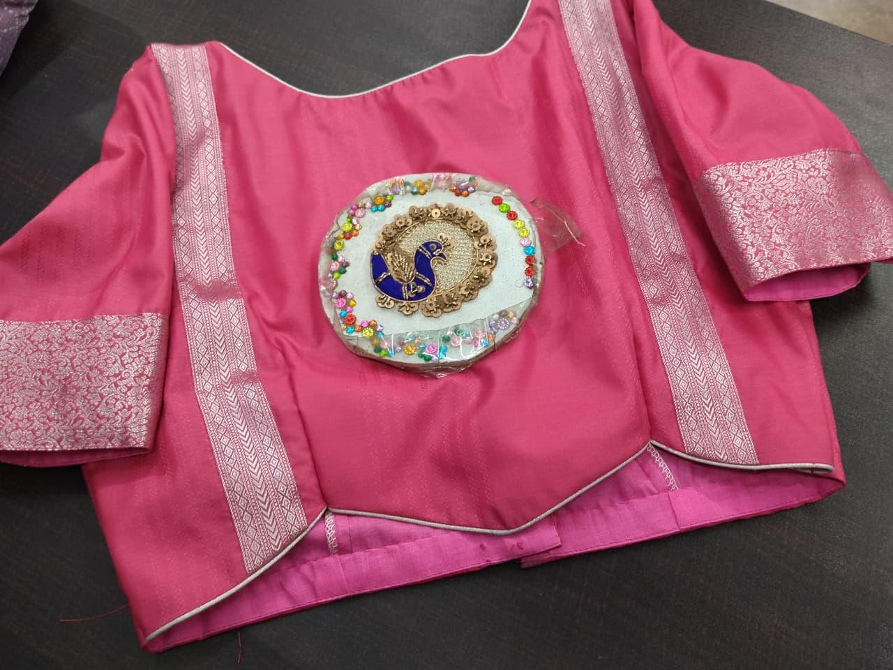 Pink silk blouse with zari borders and decorative peacock medallion