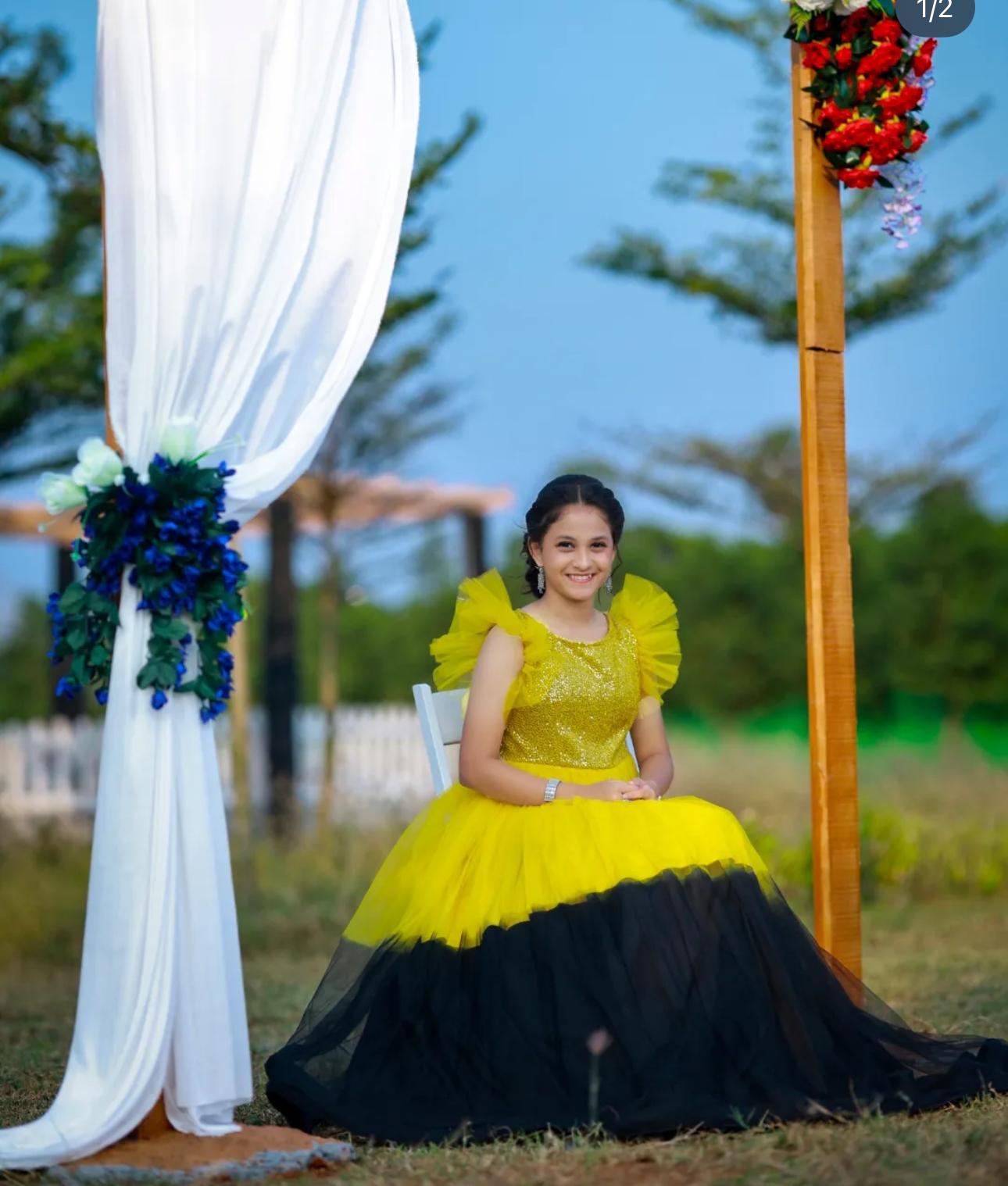 Yellow sequin bodice gown with black tulle skirt and ruffled sleeves