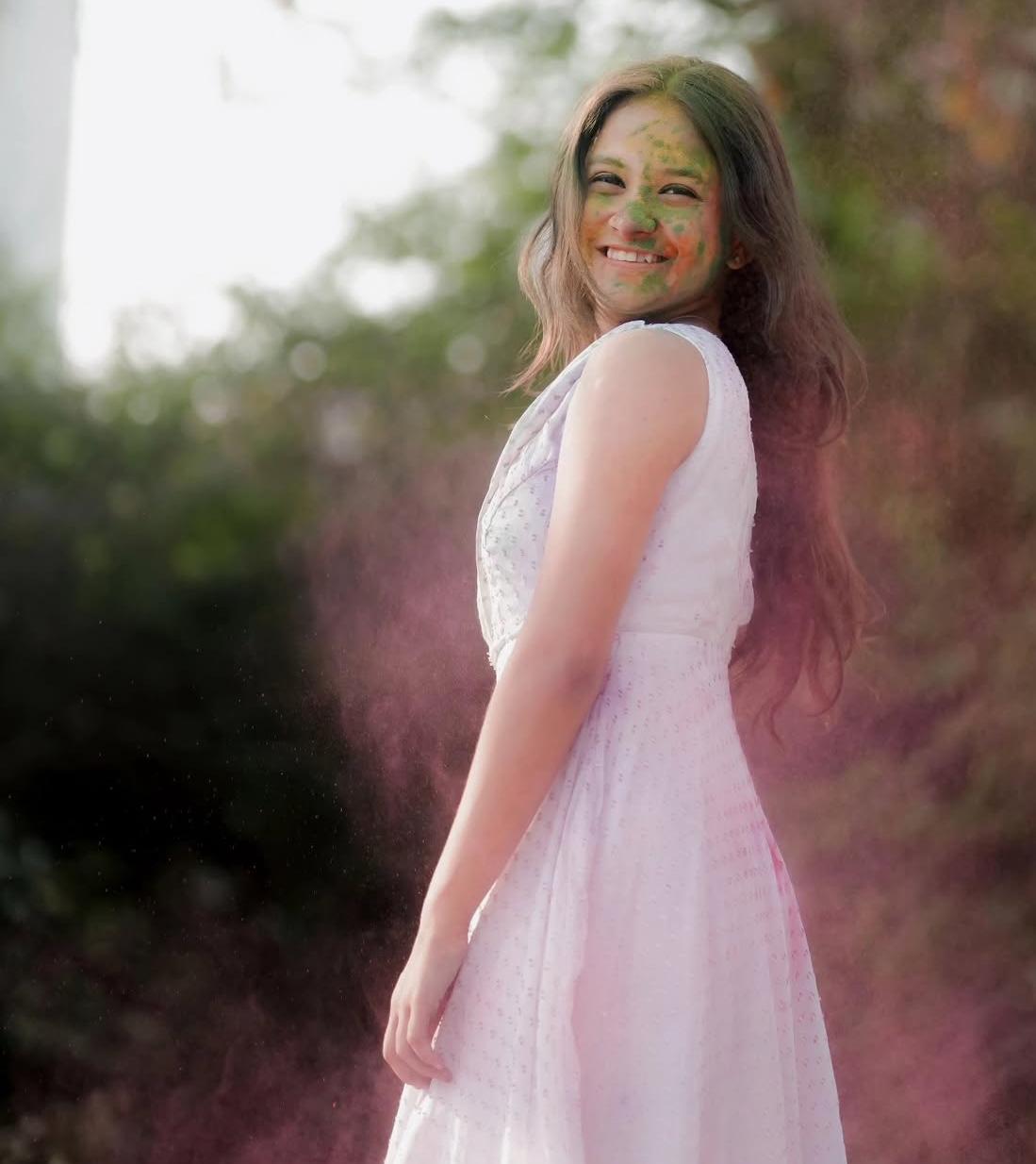 Pink sleeveless gown with colored powder festival celebration look