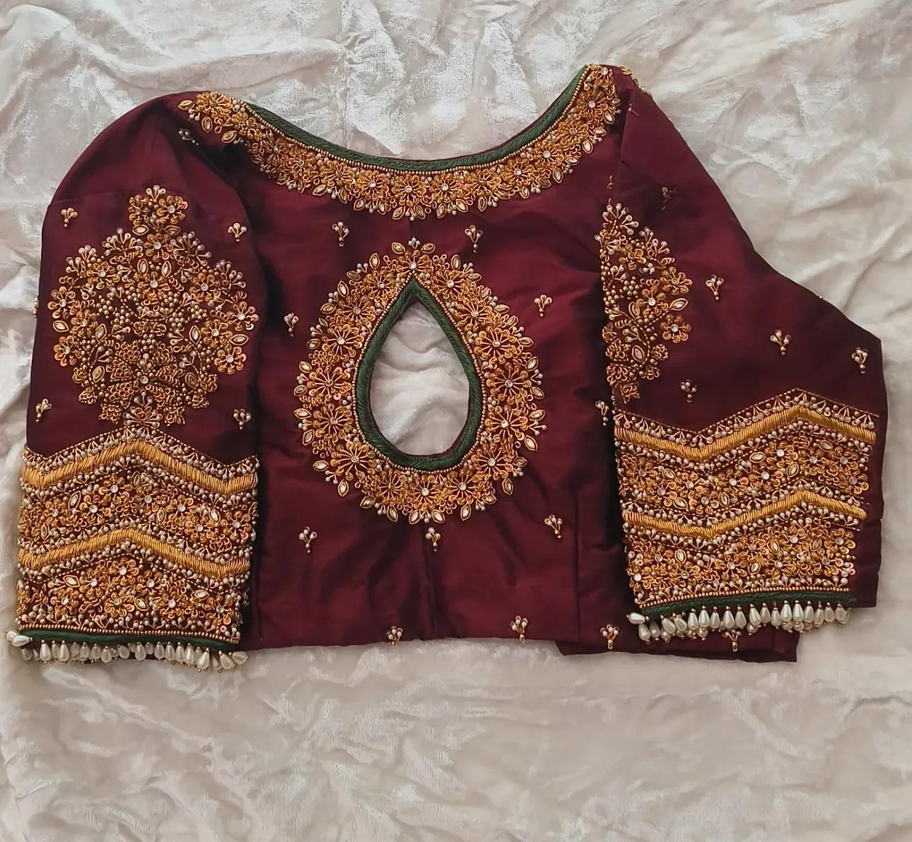 Maroon bridal blouse with gold zari and maggam work embroidery