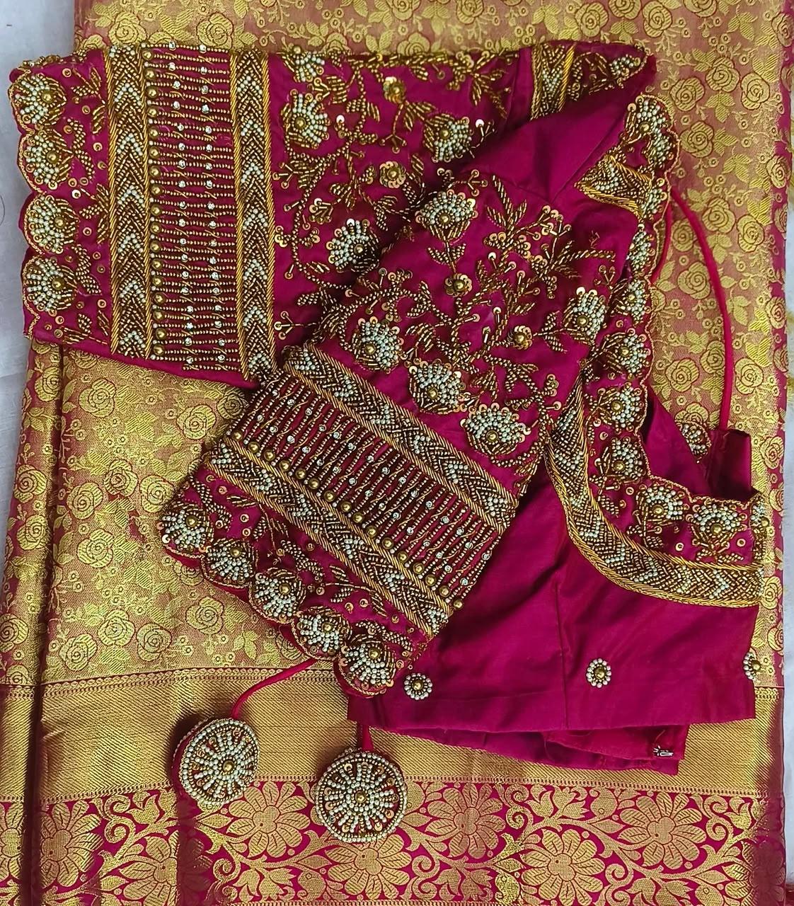 Magenta silk saree with gold zari floral embroidery and ornate blouse