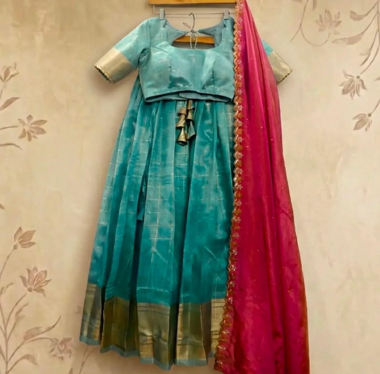 Turquoise silk half saree with gold border and pink dupatta