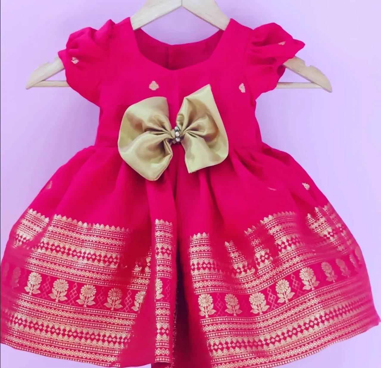 Hot pink girls party wear dress with gold zari embroidery and bow detail