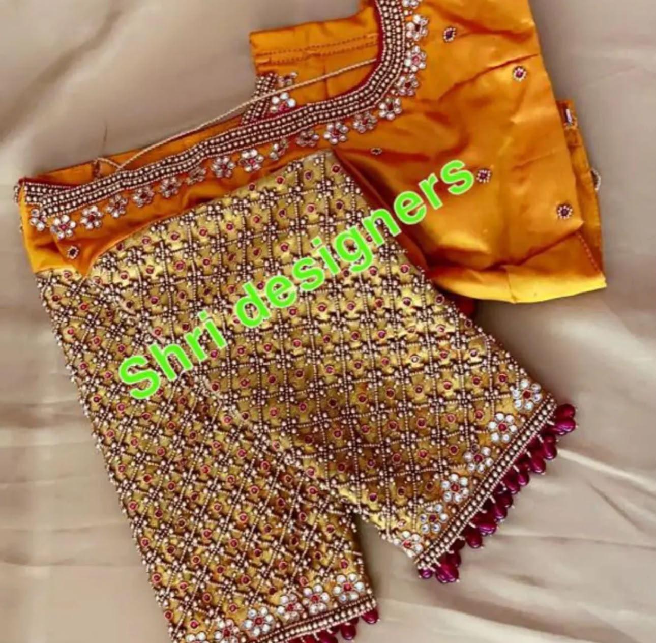 Gold bridal blouse with dense maggam work and purple accents