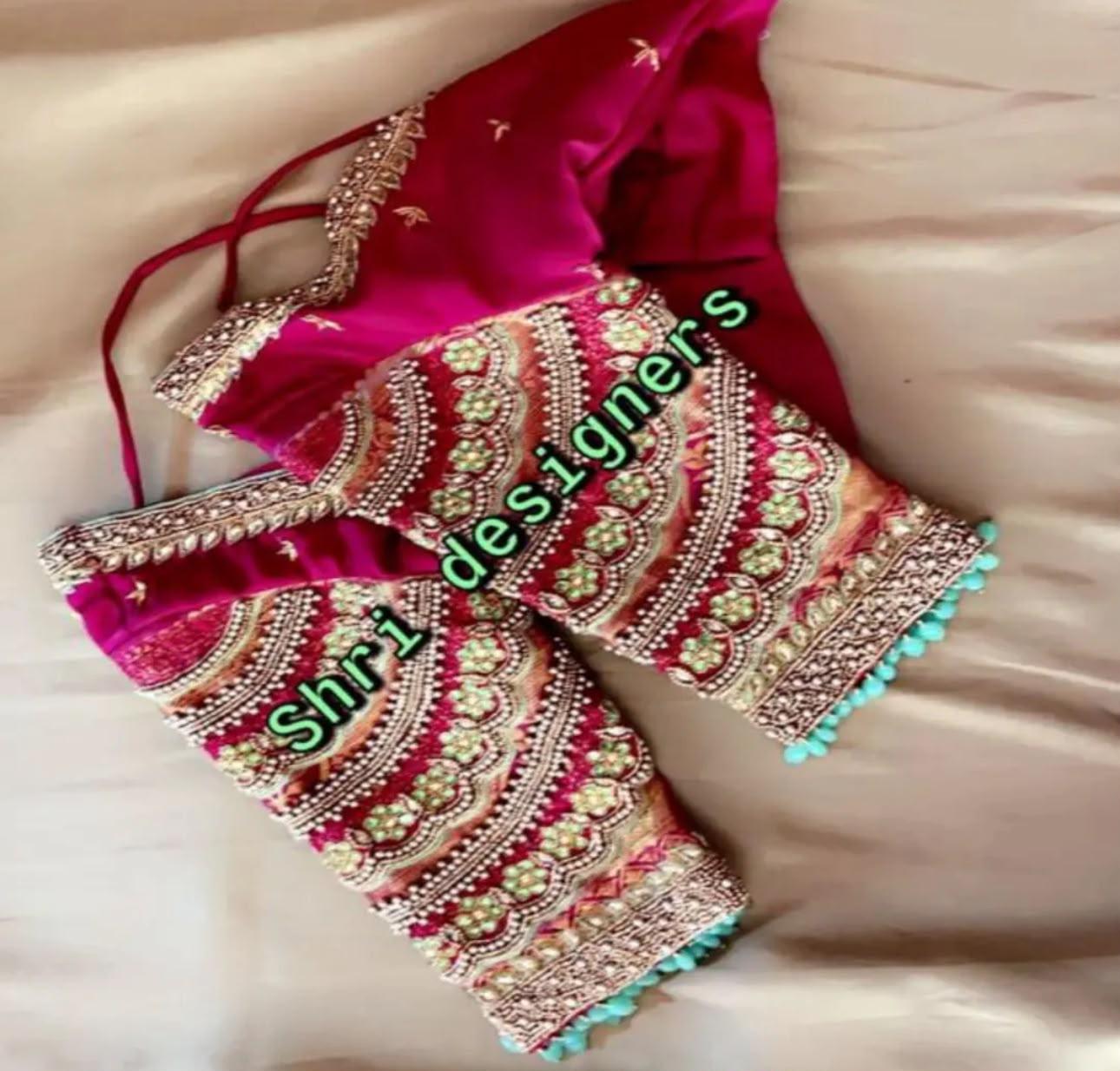 Magenta bridal blouse with ornate zari and pearl maggam work