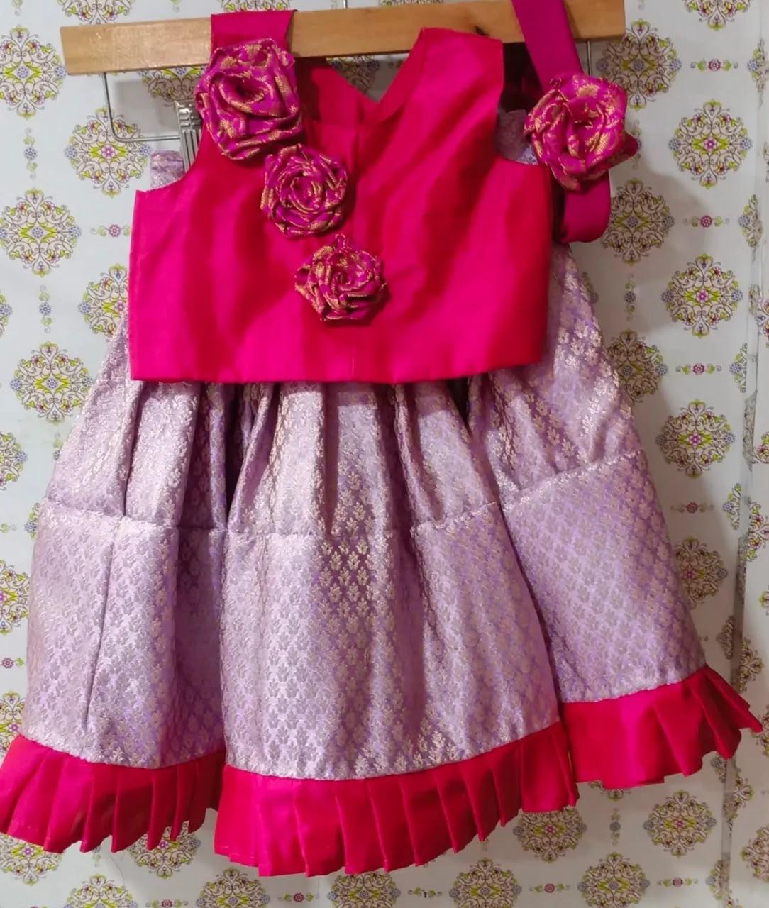 Bright pink silk blouse with gold floral embellishments and lavender lace skirt