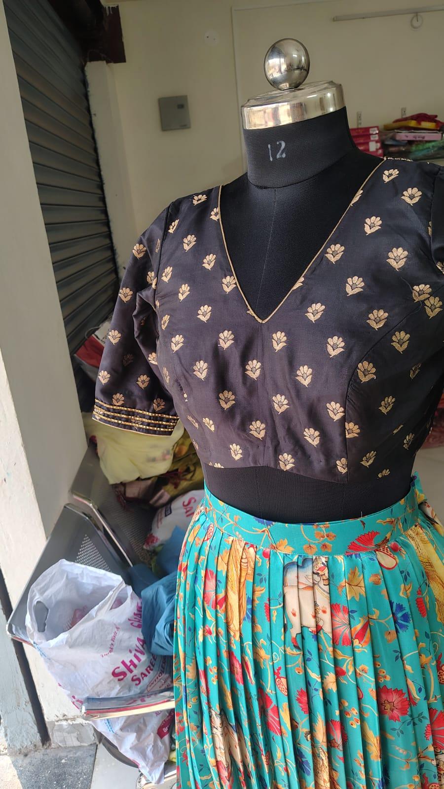 Navy floral blouse with gold leaf motifs and decorative neckline