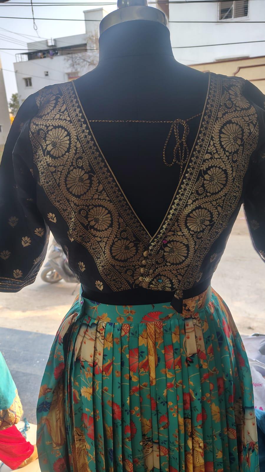 Black blouse with gold zari floral embroidery and floral skirt