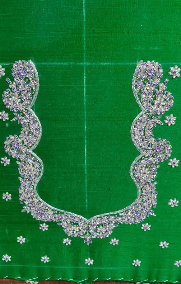 Green saree with elaborate purple and silver maggam work borders