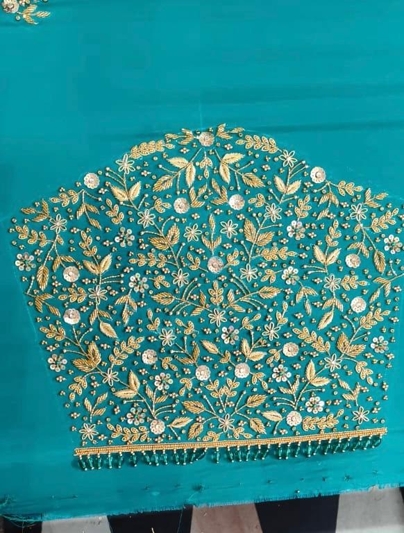 Teal blouse with dense gold zari and stone embroidery work