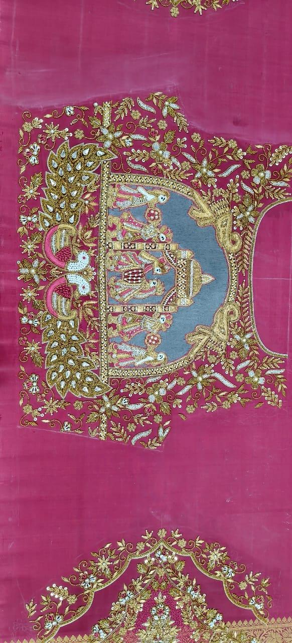 Magenta silk saree with gold zari floral embroidery and traditional temple motif