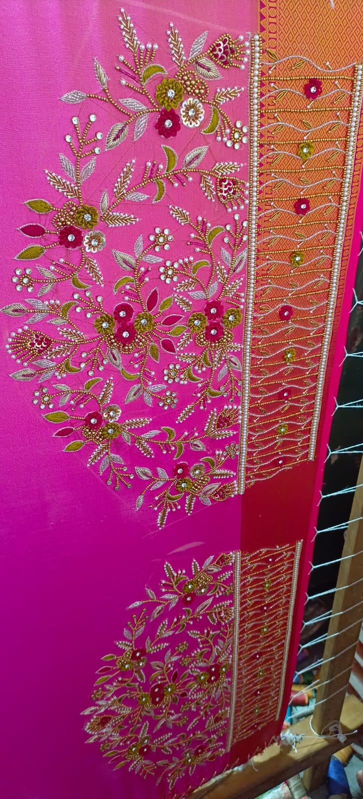 Bright pink saree with elaborate gold zari and floral maggam work embroidery