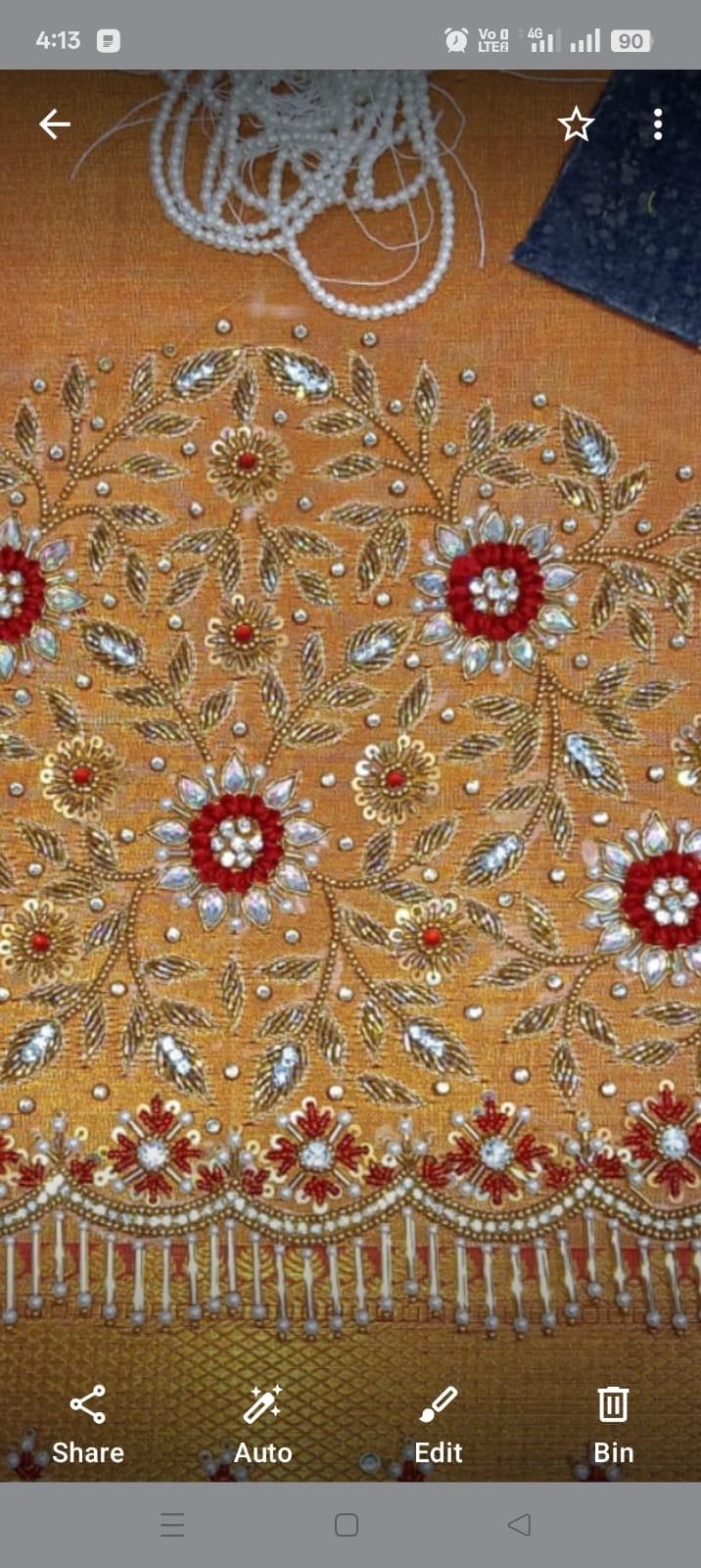 Gold bridal blouse with red floral maggam work and pearl embellishments