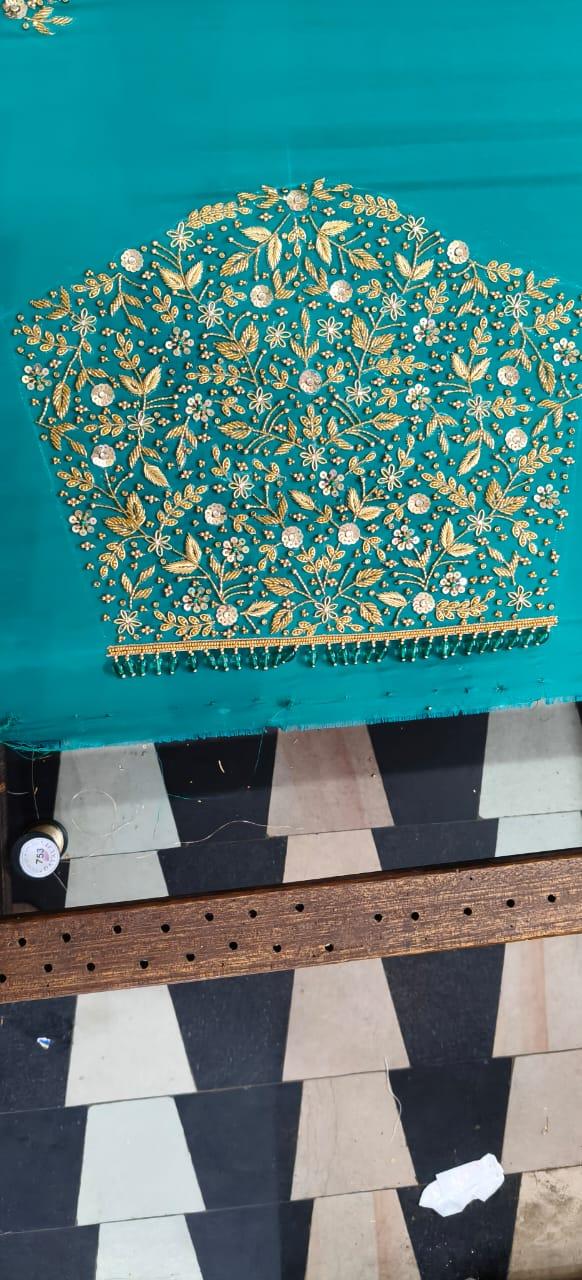 Turquoise blouse with dense gold zari floral and leaf embroidery