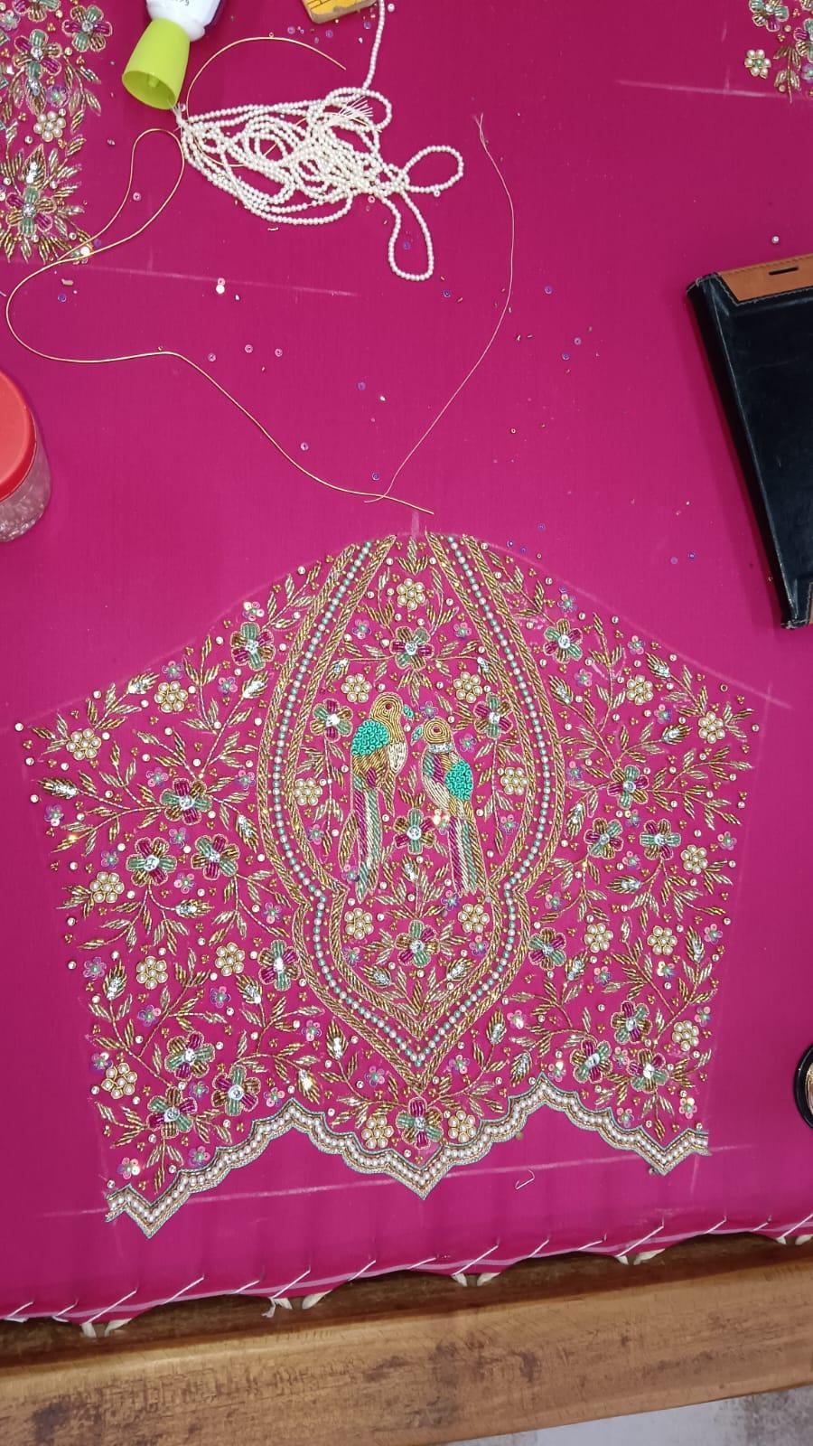 Magenta bridal blouse with dense gold zari and pearl maggam work