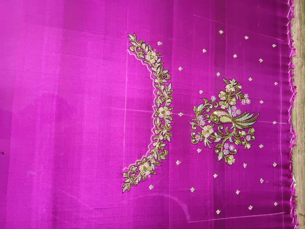 Magenta silk saree with gold zari floral embroidery and scattered accents