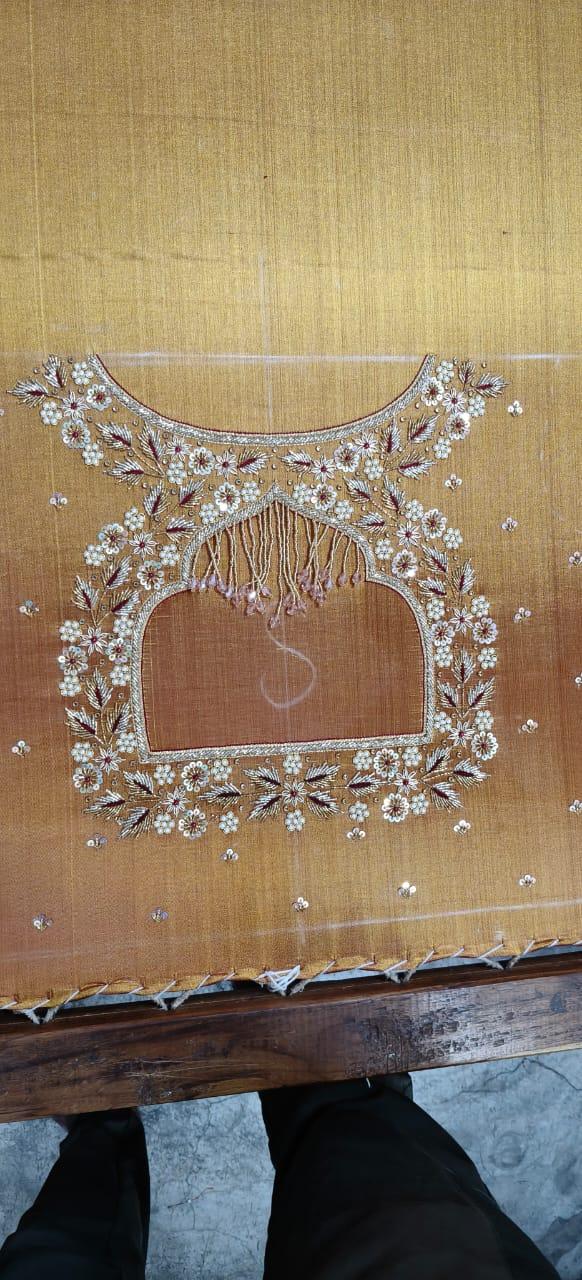 Gold silk blouse with white floral maggam work and fringe detail