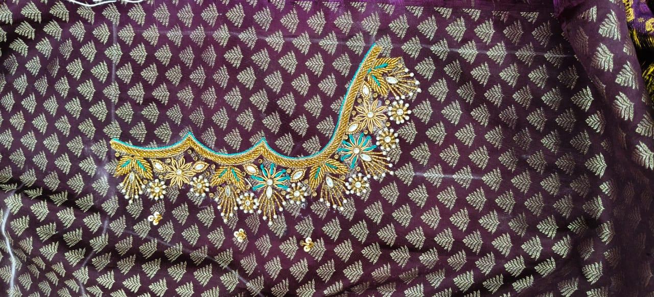 Purple silk fabric with gold zari leaf pattern and ornate embroidered neckline