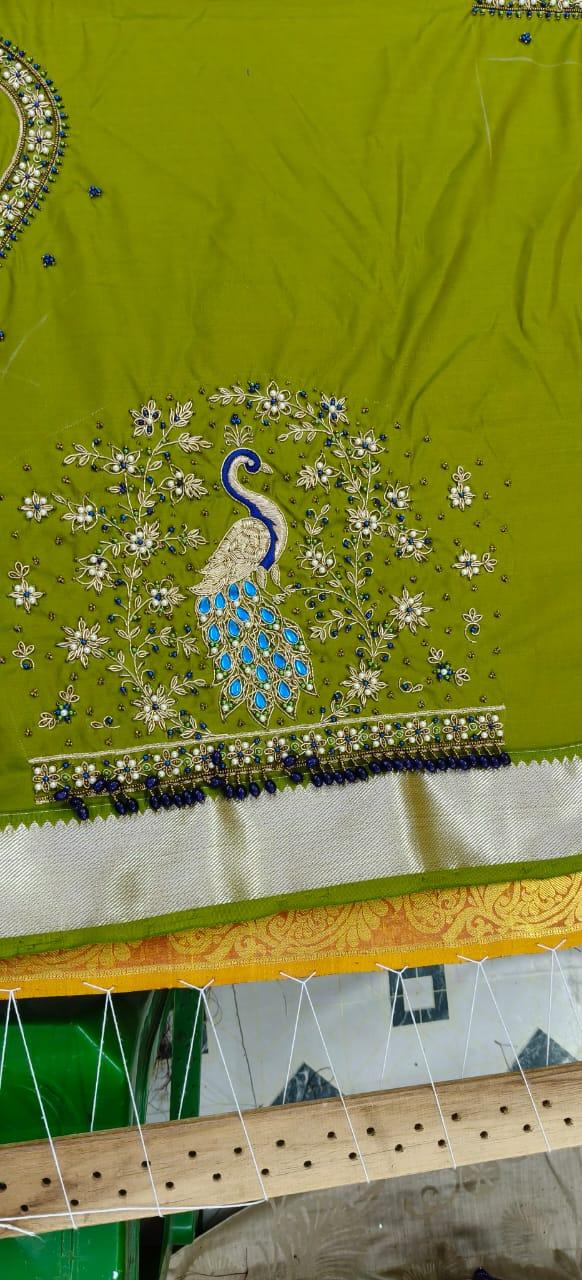Lime green saree with peacock motif and floral embroidery