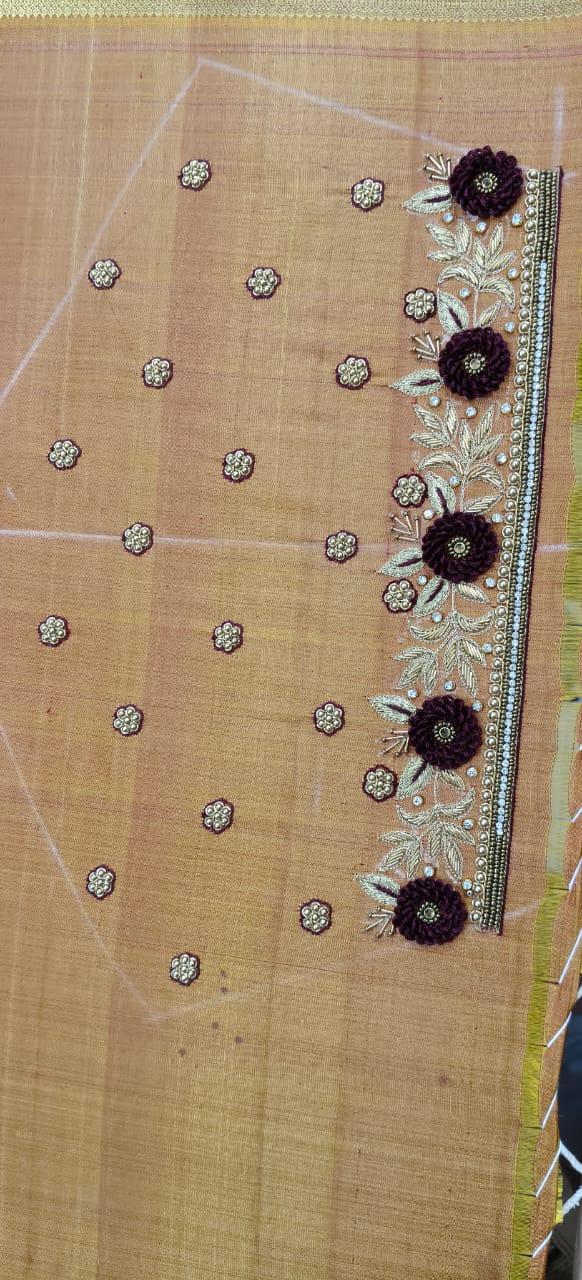 Beige saree with scattered stone work and embroidered border featuring floral motifs