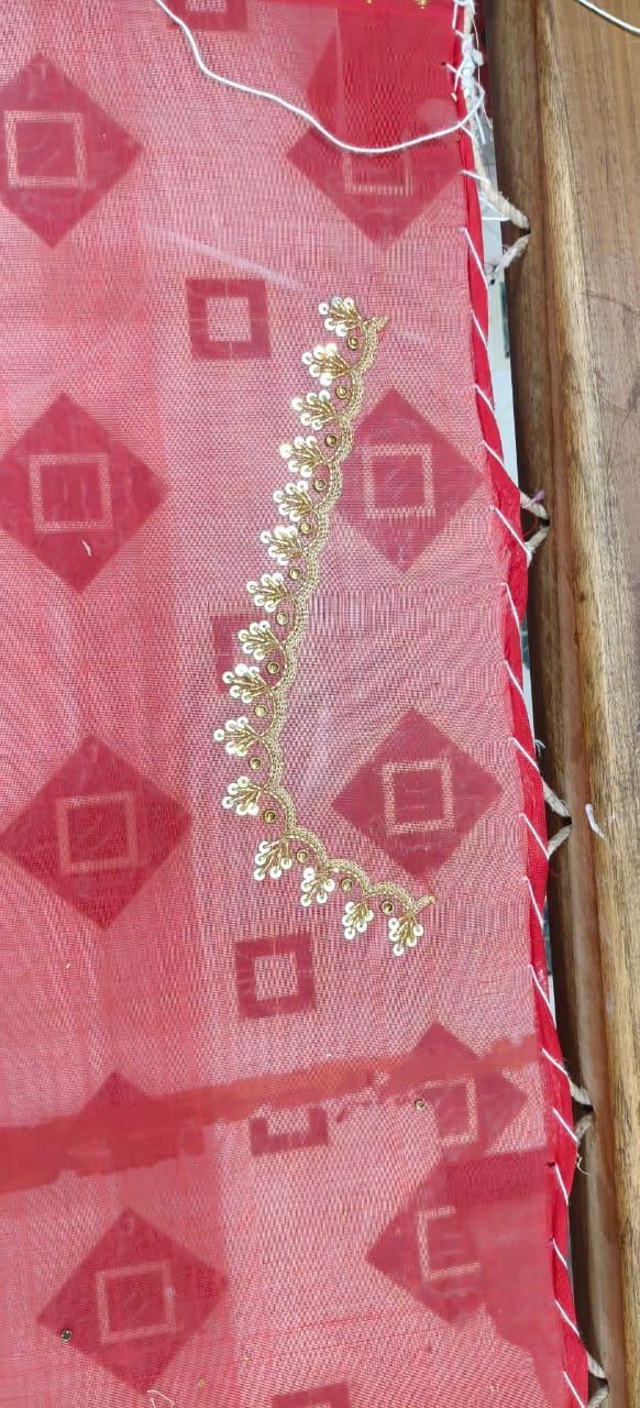 Pink saree with geometric patterns and gold zari embroidery trim