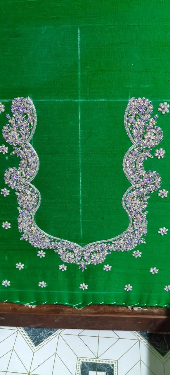 Green saree with ornate silver and purple maggam work border