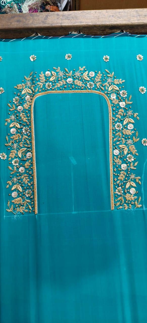 Turquoise saree with gold zari floral embroidery and beaded border