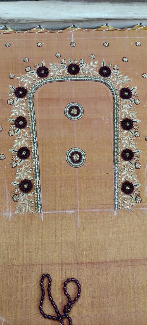 Cream blouse with dark floral maggam work and ornate border design