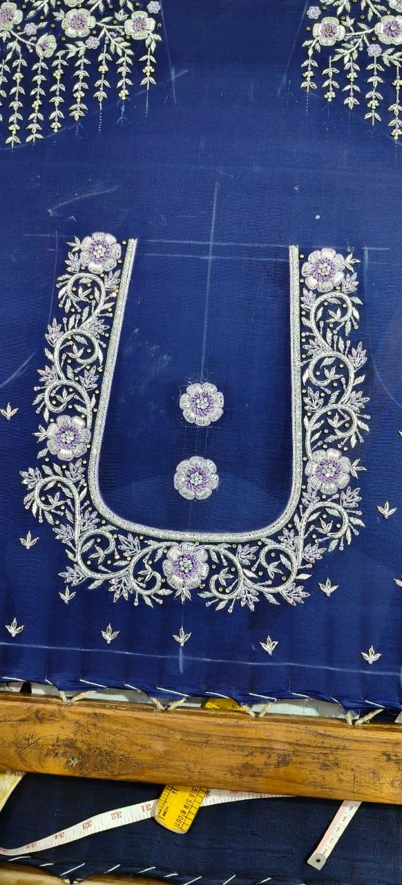 Royal blue designer blouse with gold zari embroidery and purple floral motifs