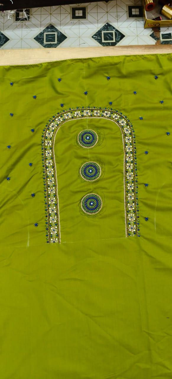 Lime green saree with ornate gold and white embroidered border design