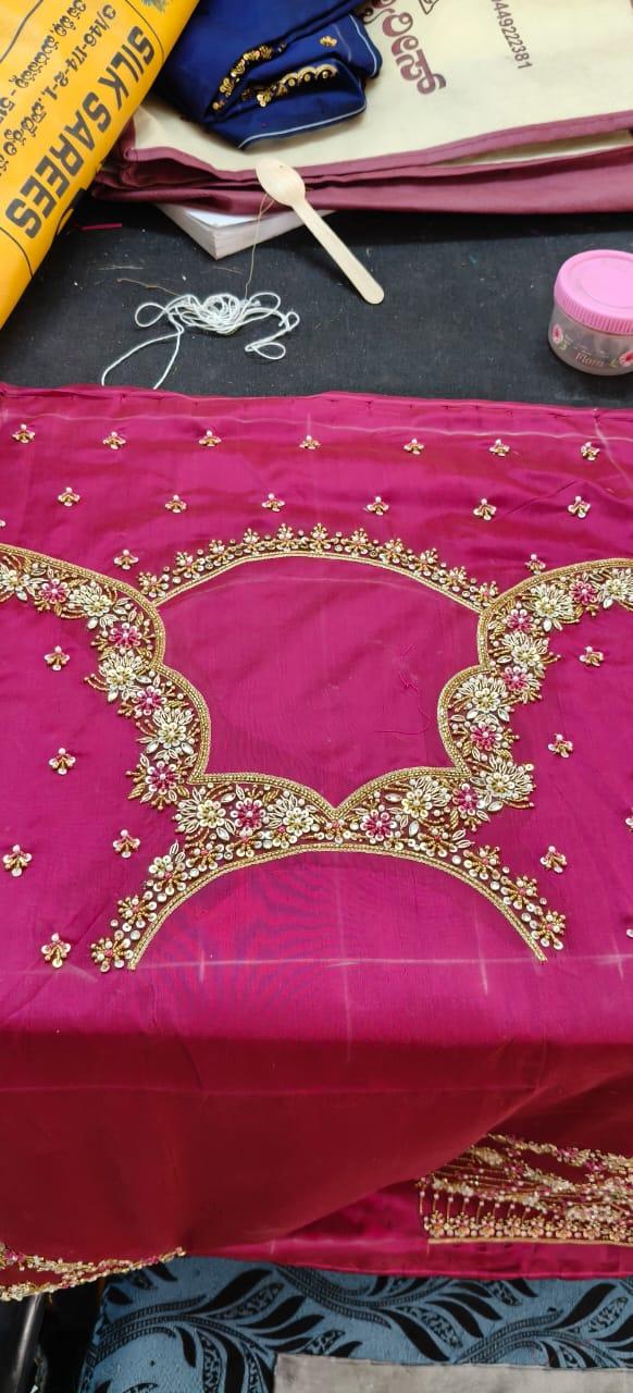 Magenta bridal blouse with gold zari floral embroidery and sequins