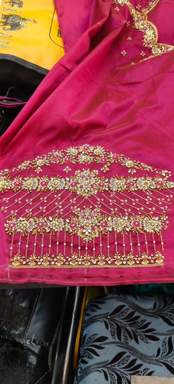 Magenta silk saree with elaborate gold zari floral embroidery and hanging beads
