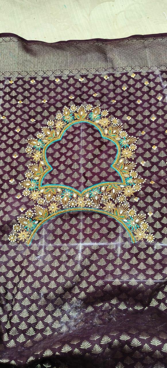 Purple saree with gold leaf motifs and ornate blue embroidered borders